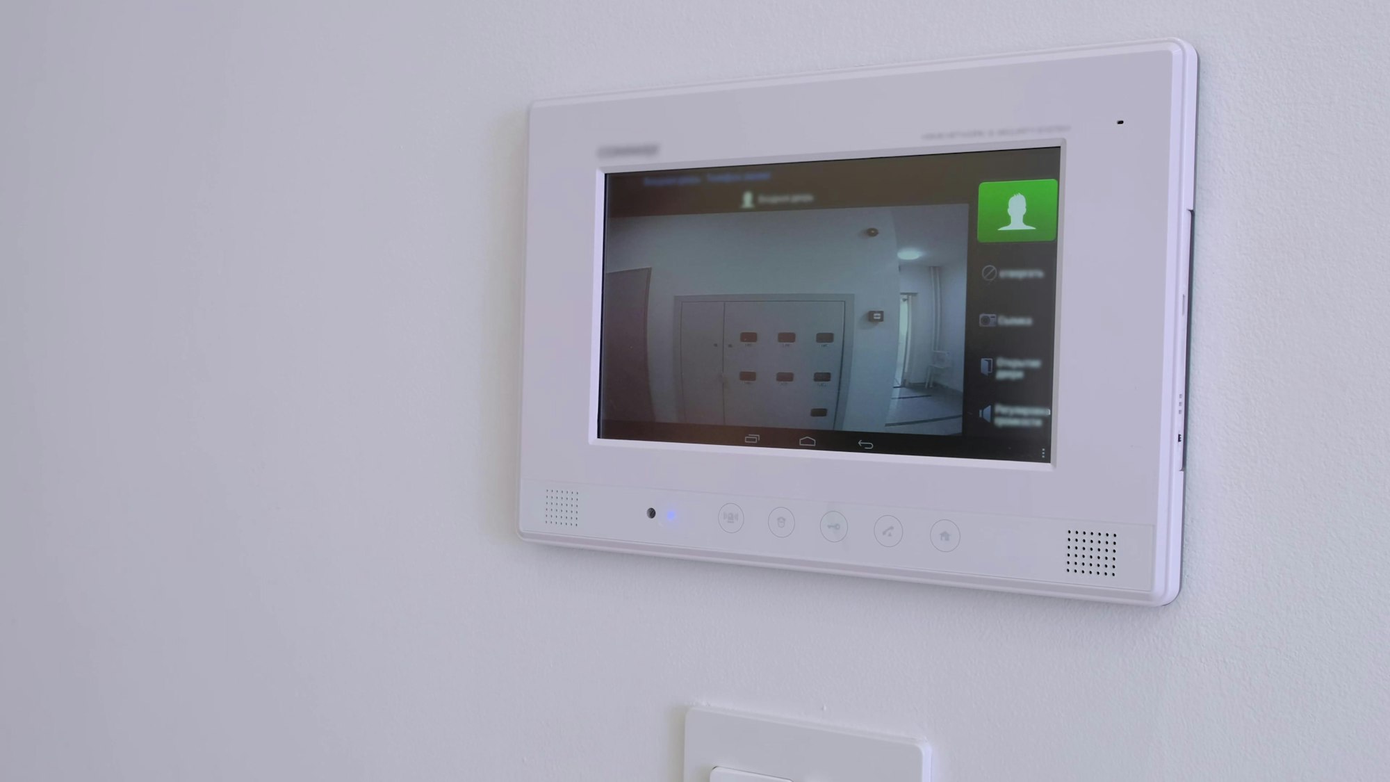 smart home a man answers a call to the intercom side view monitoring unlock apartment video